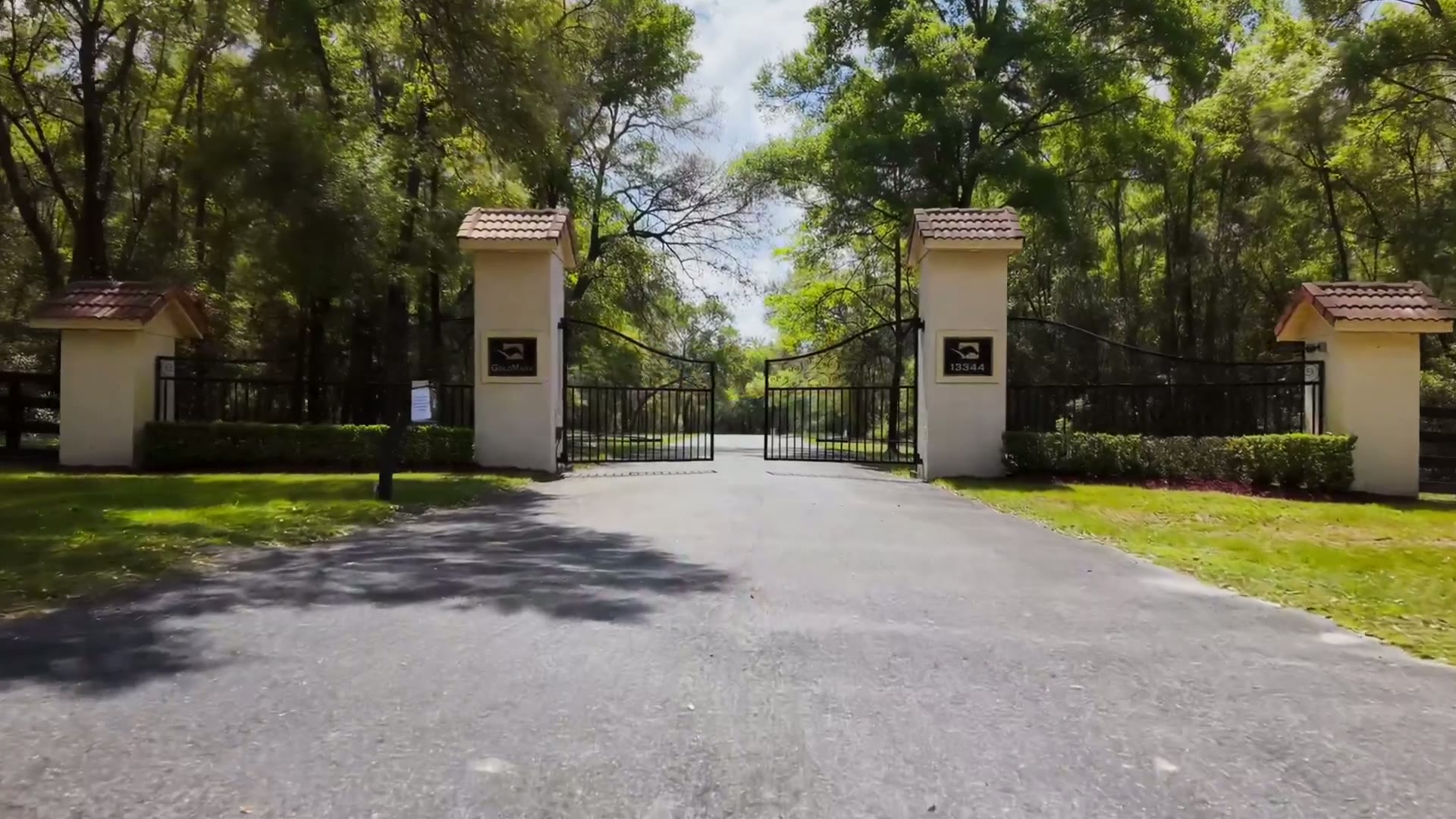 The GoldMark Farm logo over the estate entrance gates